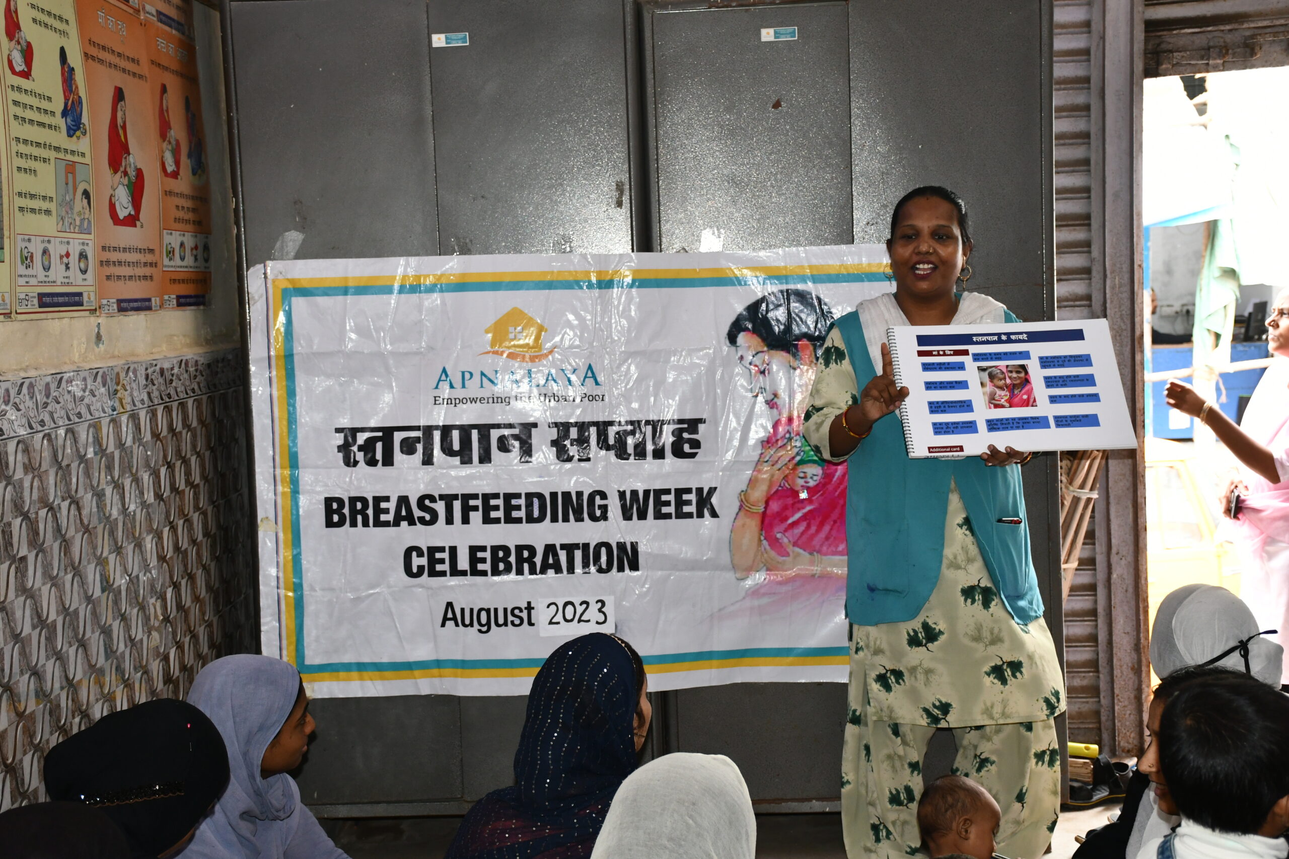 an image of apnalaya volunteer creating awareness during breastfeeding week